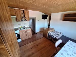 a small room with a bed and a kitchen at RETRO Apartmány Podhájska in Podhájska +24 photos