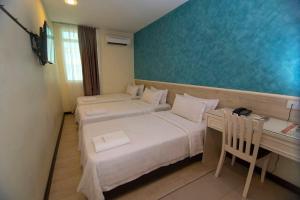 Postelja oz. postelje v sobi nastanitve Pantai Inn Kota Kinabalu