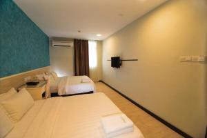 Postel nebo postele na pokoji v ubytování Pantai Inn Kota Kinabalu
