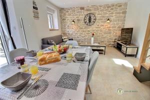 a dining room with a table with food on it at Ty feuteun in Lanvellec +22 photos