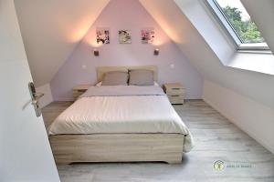 a bedroom with a large bed in a attic at Ty feuteun in Lanvellec