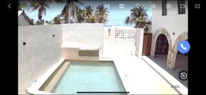 a swimming pool in front of a building at Casa Laura Azul in El Cuyo