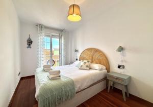 a bedroom with a large bed and a green ottoman at Xivares playa in Carrió +19 photos