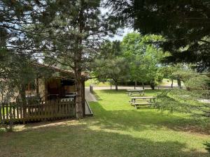 a group of picnic tables in a park at Chambre Panoramique Bellevue in Bellegarde-Adoulins +5 photos