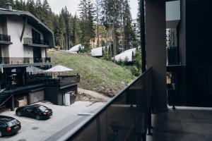 a balcony with two cars parked in a parking lot at Hiking&Ski Hotel in Bukovel
