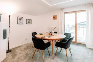 a dining room with a table and chairs at Komfortable Familienwohnung in Moosham +14 photos