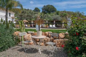 a table and four chairs in a garden at Finca Valle Verde in Alora