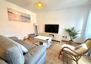 a living room with a couch and a tv at Xivares playa in Carrió