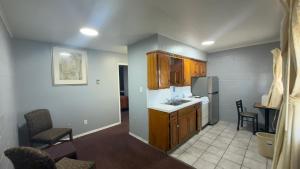 a kitchen with a sink and a refrigerator at Ada Inn & Suites in Ada