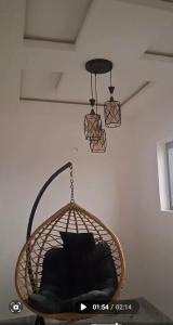 a hanging basket with a black pillow in a room at WHITE CASTLE Apartments in Hausa