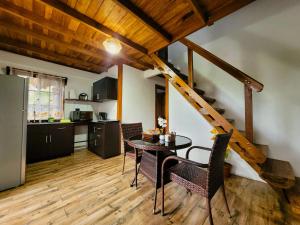 a kitchen and dining room with a table and chairs at Arenal Sweet Cabins in Fortuna +35 photos