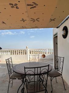 a table and chairs on a patio with a view at Sunlight guest house in Taghazout