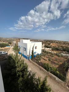 an aerial view of a white building in a field at Sunlight guest house in Taghazout