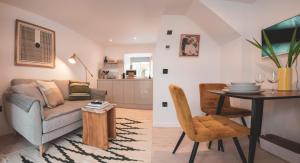 a living room with a couch and a table at Ullinish House in Ullinish