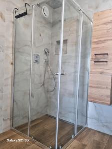 a shower with a glass enclosure in a bathroom at Domek na Sowiej in Kłodzko +10 photos
