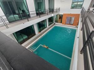 an overhead view of a swimming pool in a building at Three Bridges Hotel in Nan