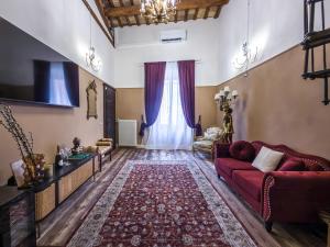 a living room with a red couch and a window at Palazzo Ravenna in Ravenna
