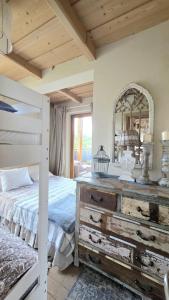 a bedroom with a bed with a dresser and a mirror at Tatrzańska Prowansja SPA&SKI Apartamenty in Zakopane