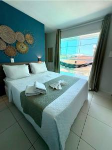 a bedroom with a large bed with towels on it at Pousada Maragolfinho in Maragogi +21 photos