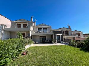a large house with a lawn in front of it at Boho Mare Retreat - Skala Fourkas in Skala Fourkas