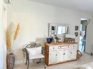 a white room with a chair and a mirror at Boho Mare Retreat - Skala Fourkas in Skala Fourkas
