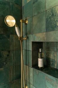 a floor lamp in a bathroom with a bottle of soap at Ô Dentelles in Vacqueyras +21 photos