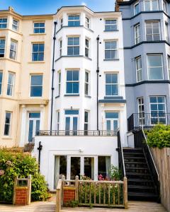 a large white building with stairs in front of it at Seascape Seaview Apartment hot tub hire subject to availability in Scarborough
