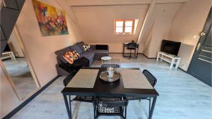 a living room with a table and a couch at Spacious Loft - Quiet and Bright in Soultz-Haut-Rhin