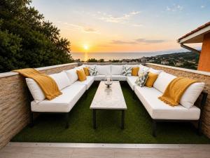 a patio with a white couch and a table at Villa Sea La Vie in Utjeha