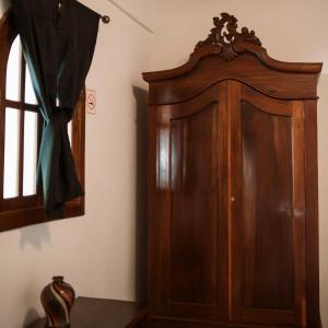 a wooden cabinet in a room with a window at Japi - Encuentros in Granada