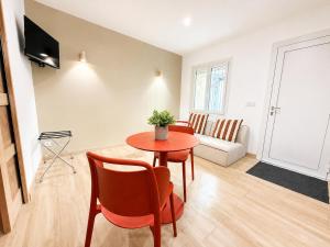 a living room with a table and chairs and a couch at Le Chabeuillois in Chabeuil