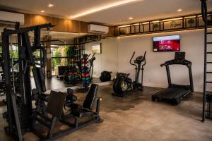 a gym with several tread machines in a room at Granterrara Hotel in Jequié