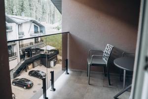 a balcony with a table and a car on it at Hiking&Ski Hotel in Bukovel