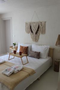 a bedroom with a bed with a table on it at Alba Terra Houses in Pamukkale