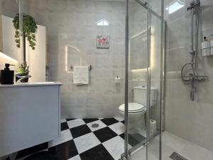 a bathroom with a toilet and a glass shower at Isabella Chipiona in Chipiona