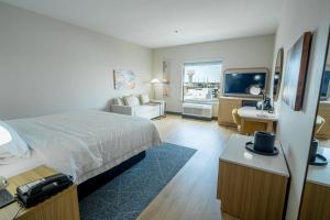 a hotel room with a bed and a television at Hampton Inn & Suites Mission in Mission
