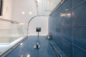 a room with a blue tiled floor with a machine at Levante - charming apartment with sea-view terrace, fits up to 7 guests in Maiori +52 photos