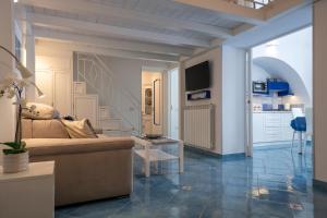 a living room with a couch and a staircase at Levante - charming apartment with sea-view terrace, fits up to 7 guests in Maiori