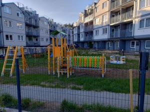 a playground in front of some apartment buildings at Róża Wiatrów Leśny Klif in Debina