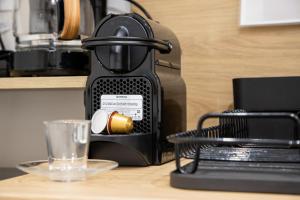a coffee maker sitting on a counter with a cup at Almond Jacuzzi Suites - Private Indoor Jacuzzi - Self Check-In - Free & Easy Street Parking in Thessaloniki