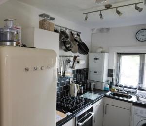 a kitchen with a refrigerator and a stove at Century Apartments Manchester in Dukinfield