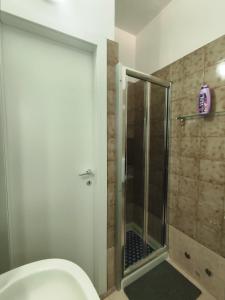 a bathroom with a toilet and a glass shower at luxury studio in Gallipoli +8 photos