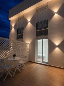 a dining room with a table and chairs and a window at Vila Gabriel in Shkodër