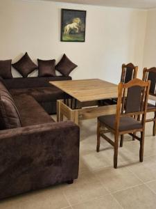 a living room with a couch and a table and chairs at Rich Garden House in Vanadzor
