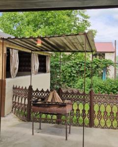 a fence with a piano in front of a house at Rich Garden House in Vanadzor