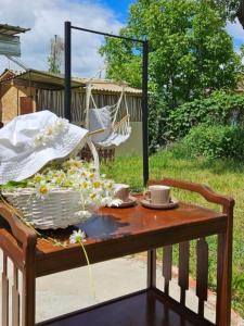 a table with a basket of flowers on a swing at Rich Garden House in Vanadzor +23 photos