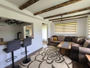 a living room with a couch and a table at Apaurin Lodge - Peacful Nature Escape near Bosnian Pyramids in Visoko +16 photos