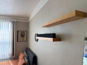 a living room with a shelf on the wall at Apex Residence The Lake Merrit Hause in Oakland