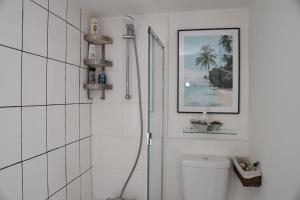 a white bathroom with a shower and a toilet at Century Apartments Manchester in Dukinfield +12 photos