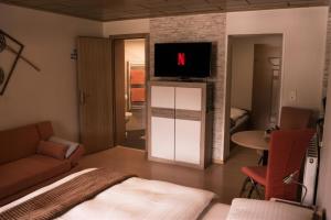 a bedroom with a bed and a tv on a wall at Landhaus am Hügel in Bad Gastein